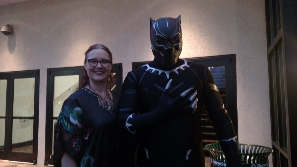 At Thursday’s premiere, Mo Vermenton, dressed as Black Panther, stands with his wife Danielle Johnson. They are part of a group called Atlanta Cosplayers and attend charity events in costume. (Kaitlyn Lewis/WABE)