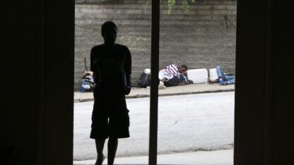 A person standing on the side of a street