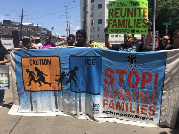 On Friday, the protesters in Atlanta chanted and held signs saying "reunite families." (Stephannie Stokes/WABE)