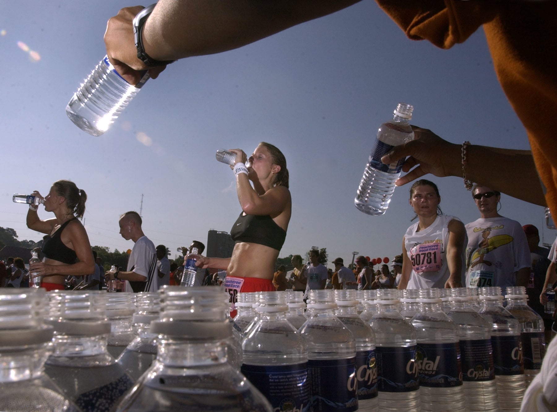 A person hands out bottled water during a race