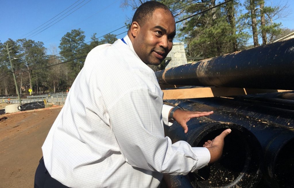DeKalb County Director of Watershed Management Reginald Wells says the pipes being laid at Milam Park in Clarkston will alleviate sewage spills and add capacity. (Molly Samuel/WABE)