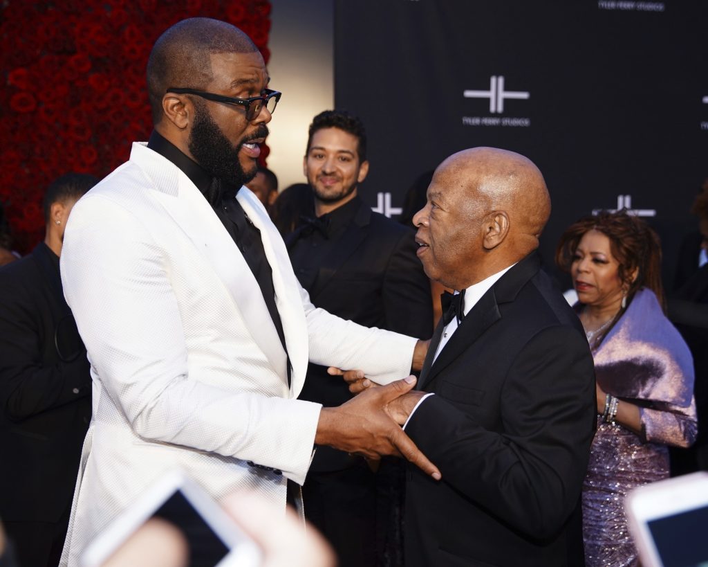 Tyler Perry, left, greets U.S. Rep. John Lewis, D-Georgia, on the red carpet at the grand opening of Tyler Perry Studios in Atlanta over the weekend. Lewis was just one of the many well-known attendees at the event. (Elijah Nouvelage/Invision/AP)