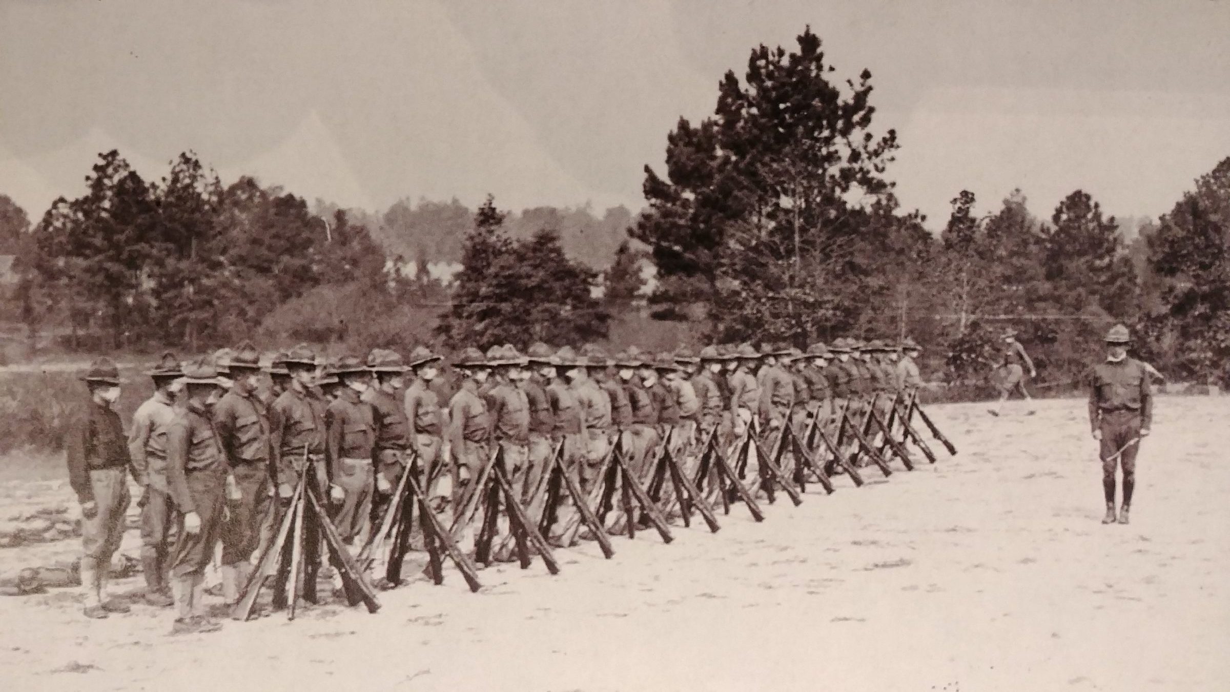 Soldiers in formation at Camp Gordon, many wearing flu masks. (Courtesy of The National Archives)