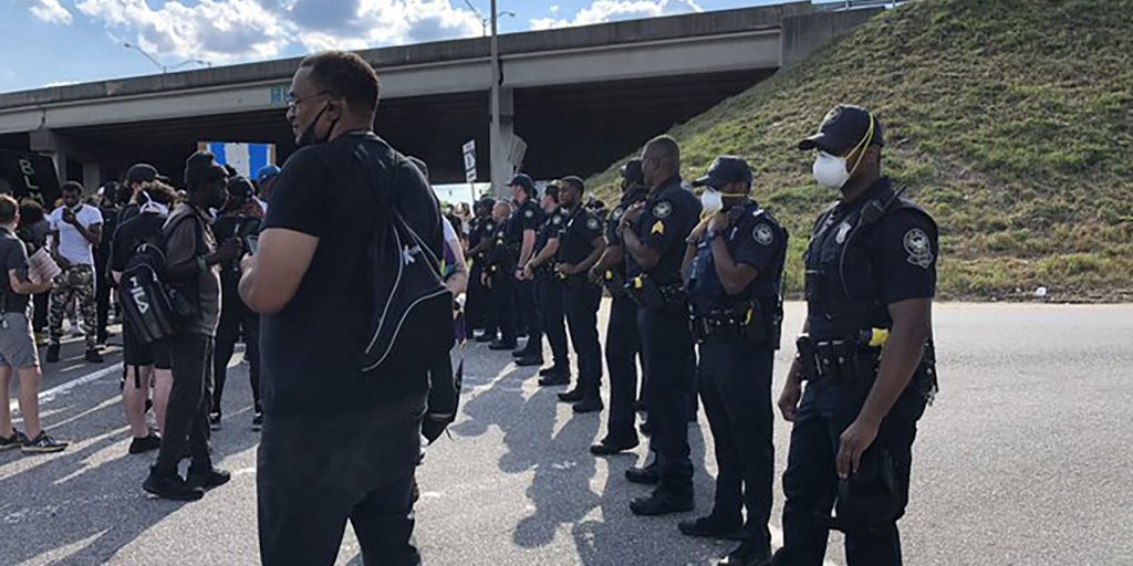 Police blocked the interstate ramp where the protesters were gathered, but some tried to get around the officers to get to the highway.