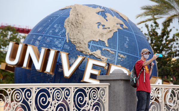 A visitor takes a selfie at Universal Studios theme park on June 5, the first day of the park's reopening during the coronavirus pandemic in Orlando, Fla.