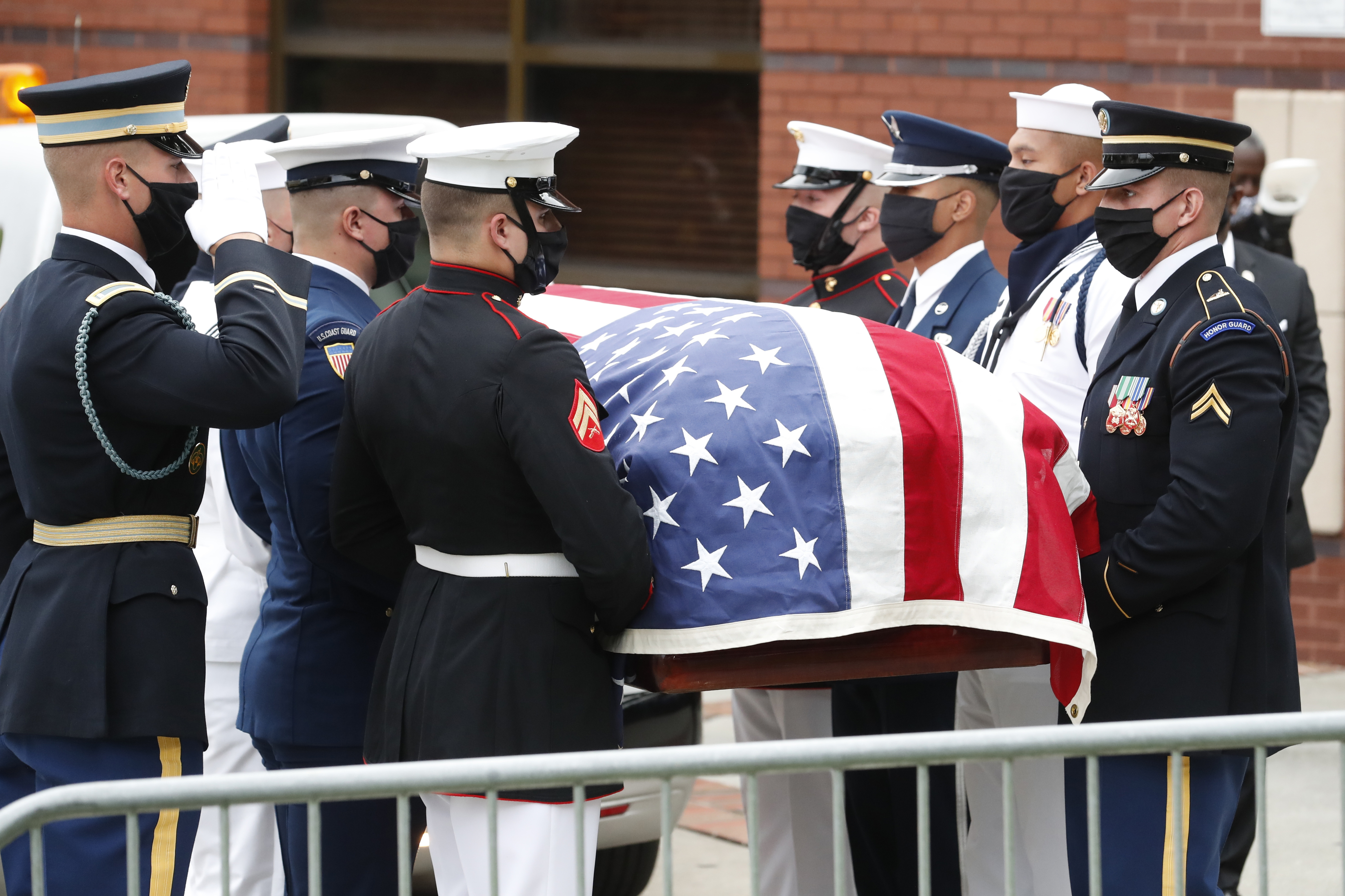 A military honor guard moved the casket of Rep. John Lewis into Ebenezer Baptist Church for his funeral, Thursday in Atlanta.