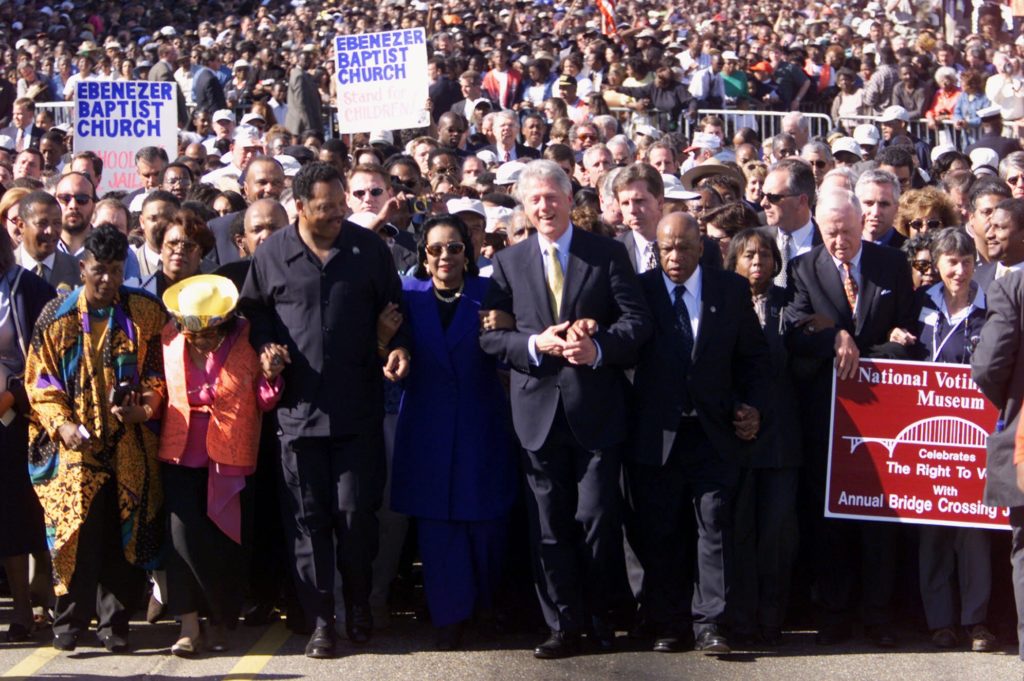John Lewis marches with then-President Bill Clinton, Jesse Jackson, Coretta Scott King, and thousands of others across the Edmund Pettus Bridge in Selma, Alabama on March 5, 2000. It was the 35th anniversary of Bloody Sunday. (J. Scott Applewhite/Associated Press)