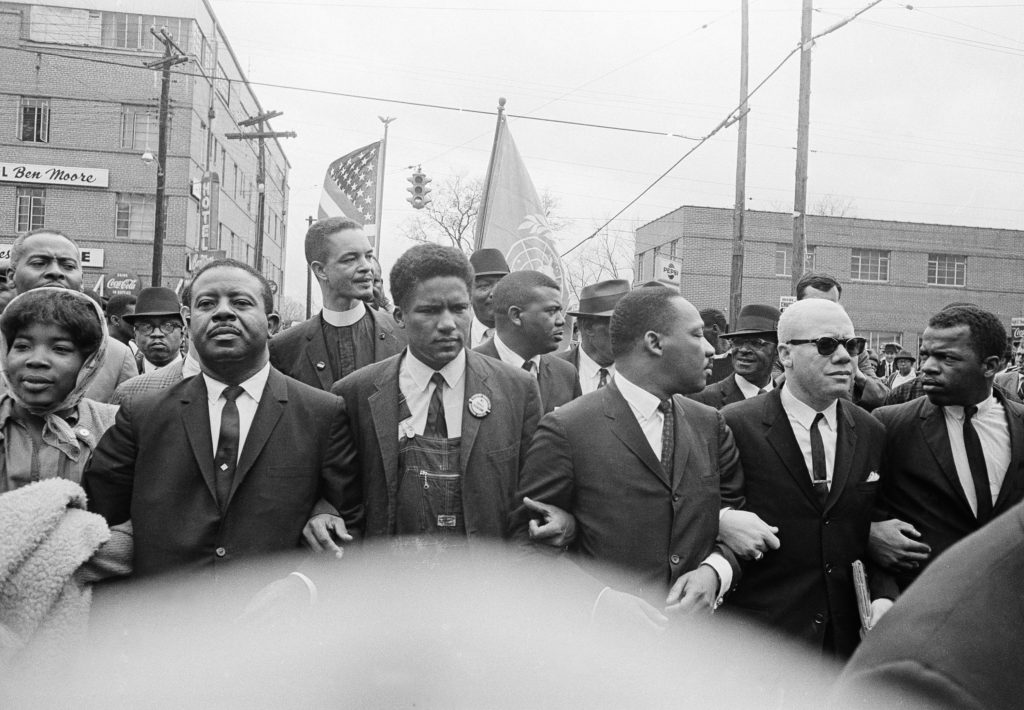 John Lewis, far right, is seen with Dr. Martin Luther King Jr. as King led a march of several thousands to the courthouse in Montgomery, Alabama, March 17, 1965. 