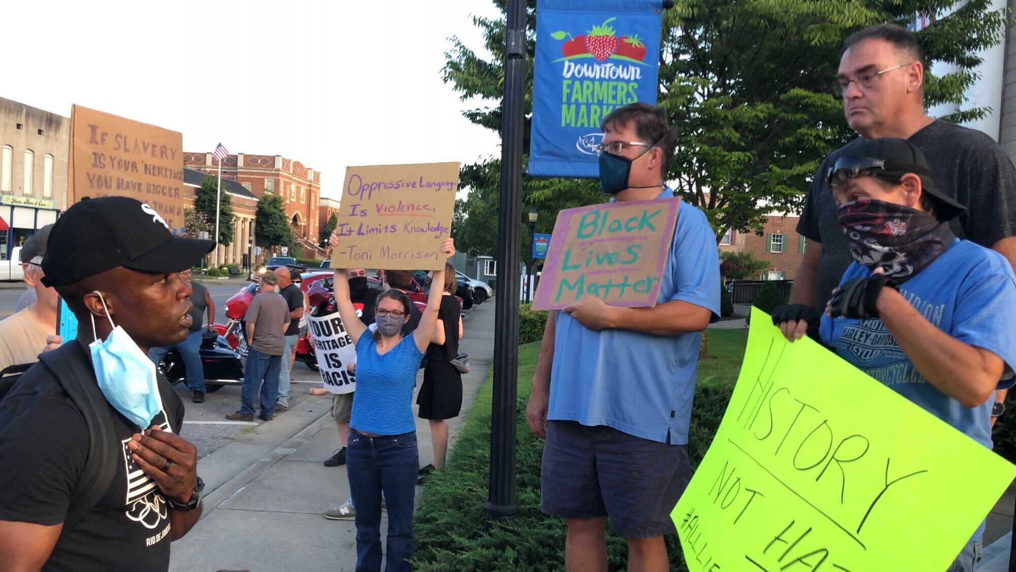 Sherman Nealle, left, speaks with protesters opposing the monument’s removal. (Liam Niemeyer/Ohio Valley Resource)