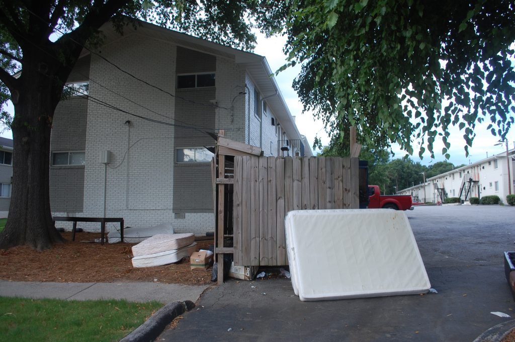 As families leave Moores Mill Village, their mattresses pile on top of the dumpsters.