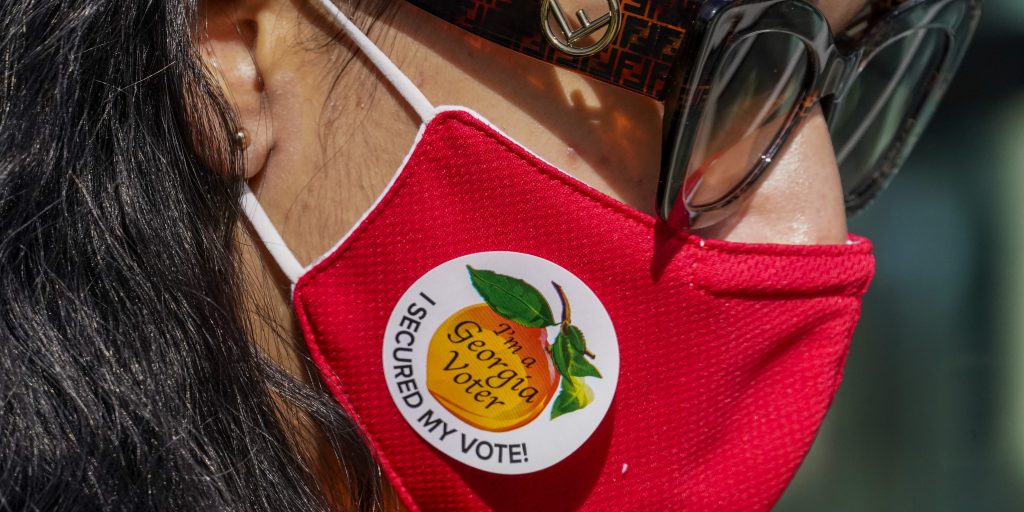A voter wears a "I'm a Georgia Voter" sticker after casting a ballot on Election Day in Atlanta.
