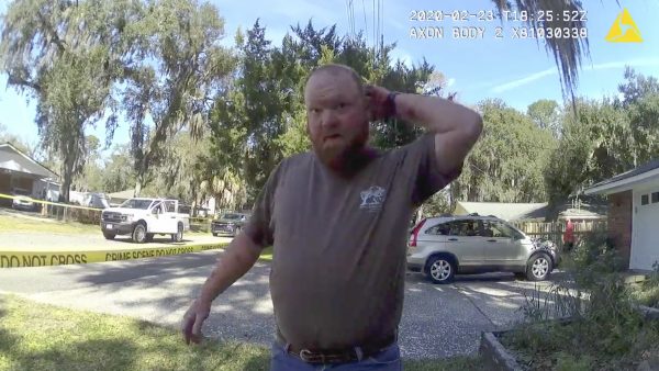 In this Feb. 23 image taken from Glynn County Police body camera video, Travis McMichael speaks to a police officer at the scene where Ahmaud Arbery was shot and killed. (Glynn County Police via AP)
