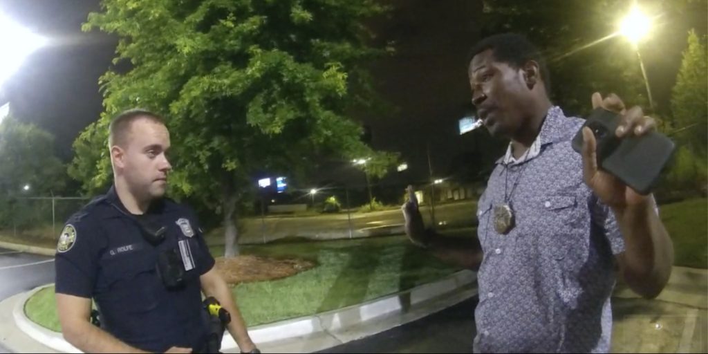 This screen grab taken from body camera video provided by the Atlanta Police Department shows Rayshard Brooks speaking with Officer Garrett Rolfe, left, in the parking lot of a Wendy's restaurant in Atlanta on June 12.