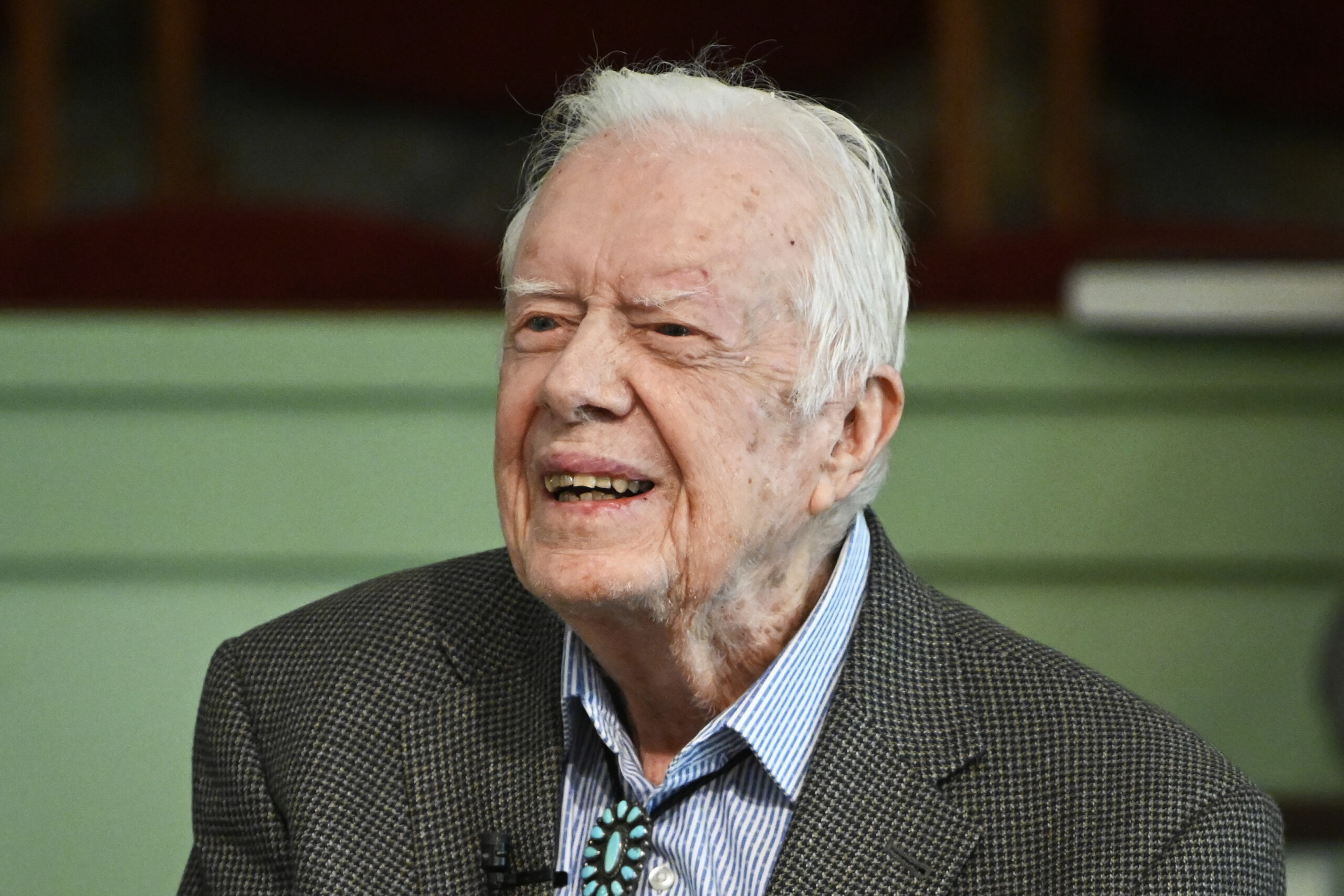 Vaccinated for virus, Jimmy Carter and wife back in church