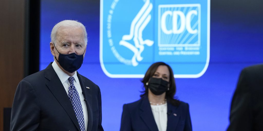 President Joe Biden and Vice President Kamala Harris listens visit the headquarters for the Centers for Disease Control and Prevention on Friday in Atlanta.