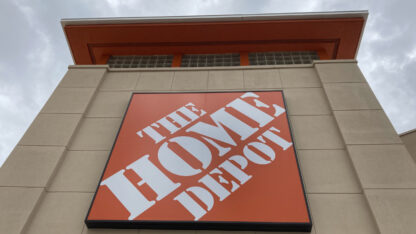 The orange logo of the Home Depot on a building