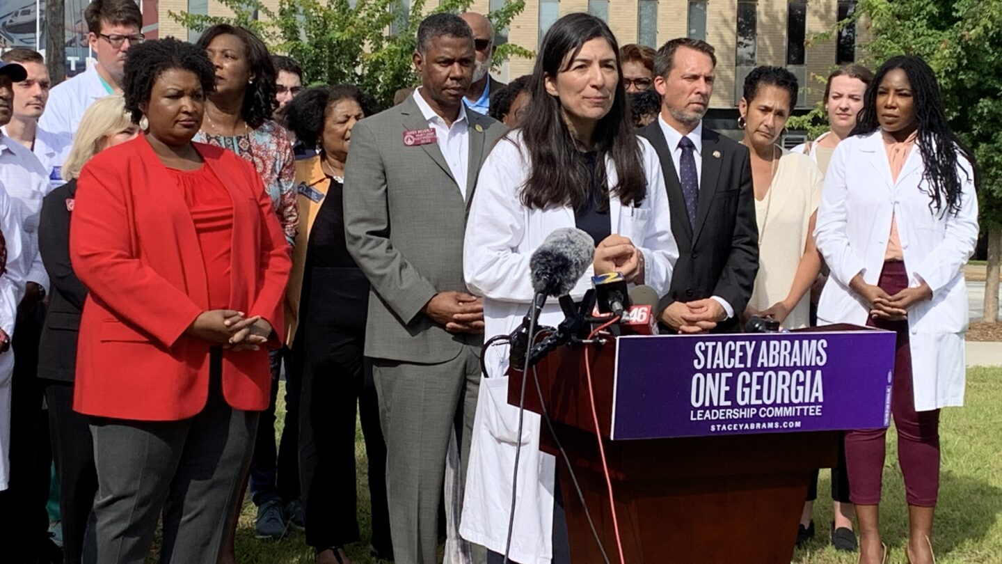 Atlanta Medical Center providers joined public officials and Stacey Abrams outside the hospital Friday. Wellstar announced plans to shutter the facility later this year. WABE/Jess Mador