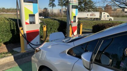 An electric vehicle charging at a power station.