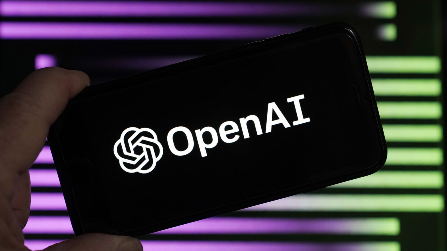 Open AI logo on a phone held up by a hand