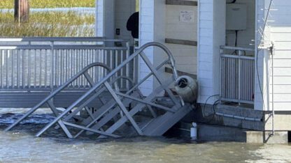 A portion of the collapsed gangway is above the water on Sapelo Island.