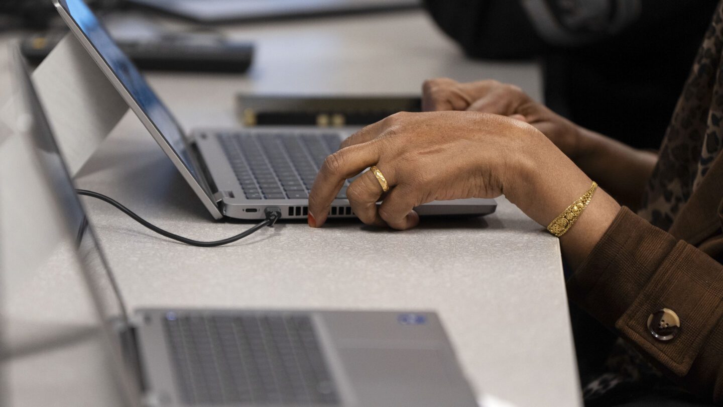 Someone types at a laptop computer.