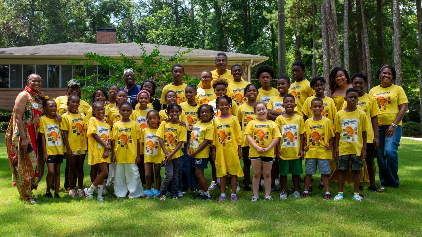 A group of students pose for a picture at OURCHIVES Summer Camp