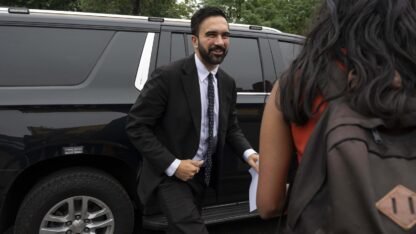 Democratic mayoral candidate Zohran Mamdani steps out of a car.