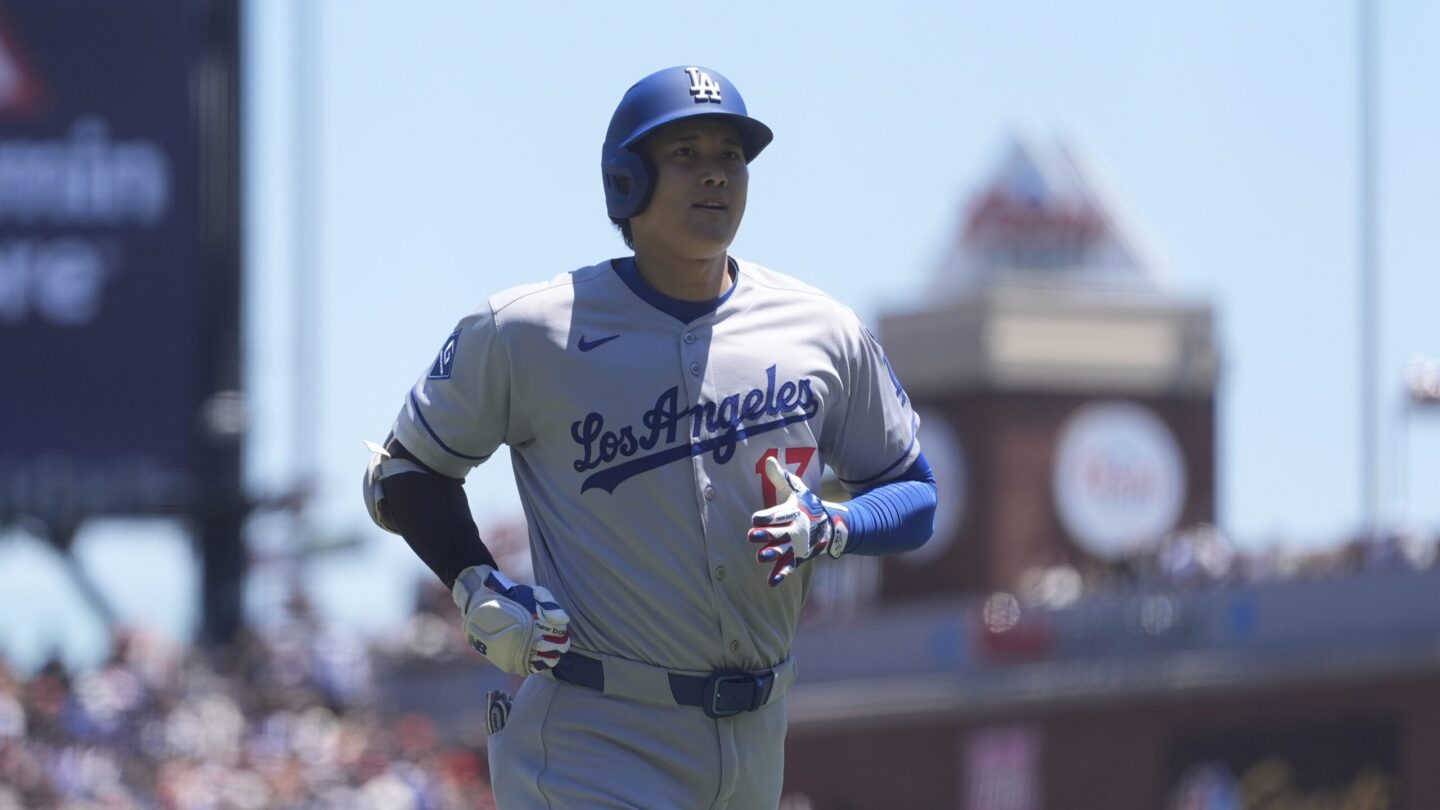 Los Angeles Dodgers designated hitter Shohei Ohtani jogs to the dugout in a game against the San Francisco Giants.