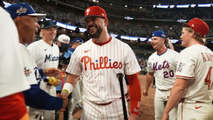 Philadelphia Phillies Kyle Schwarber walks among his fellow players.