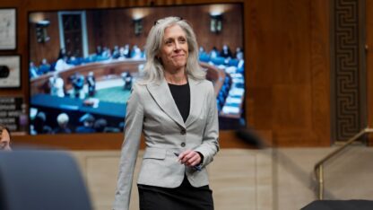 Susan Monarez walks in a US Senate building