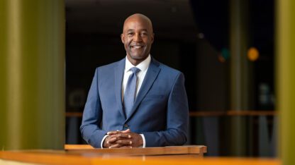 Morehouse College President Dr. F. DuBois Bowman with his hands crossed over each other.