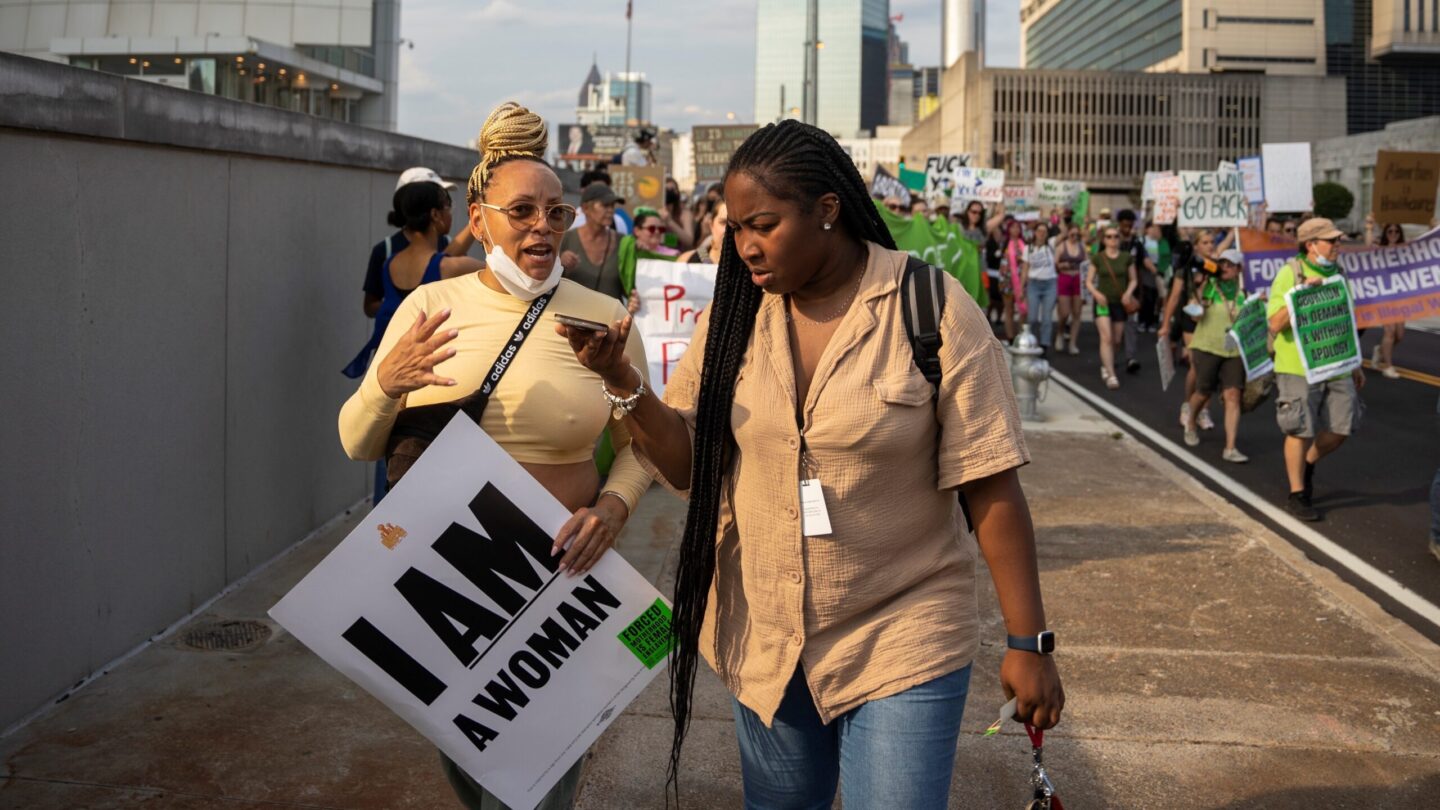 A reporter speaks with a protester in downtown Atlanta.