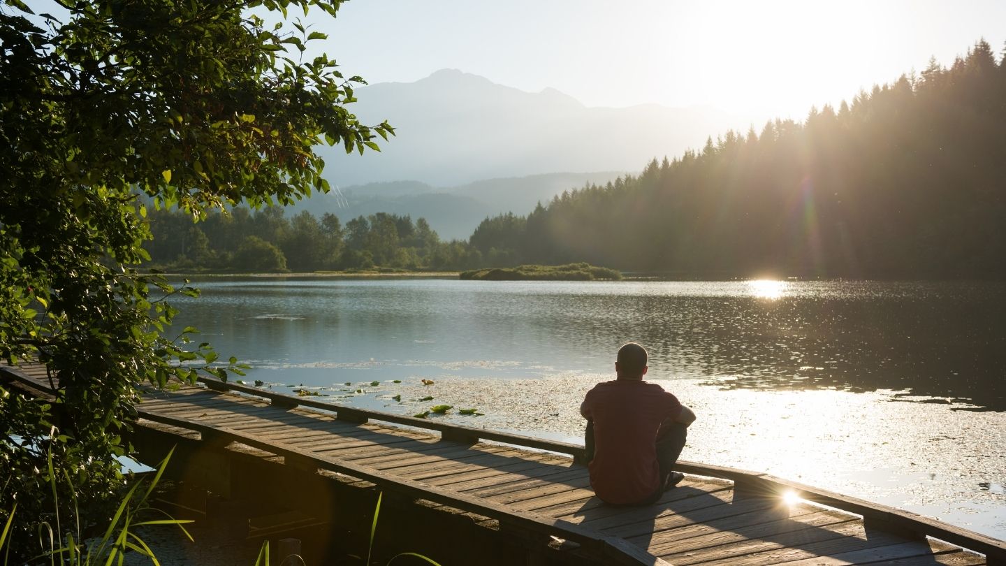 man sitting on dock