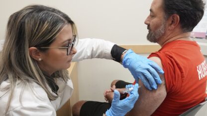 Pharmacy manager Aylen Amestoy administers a seasonal flu vaccine to a patient at a CVS Pharmacy in Miami, Tuesday, Sept. 9, 2025.