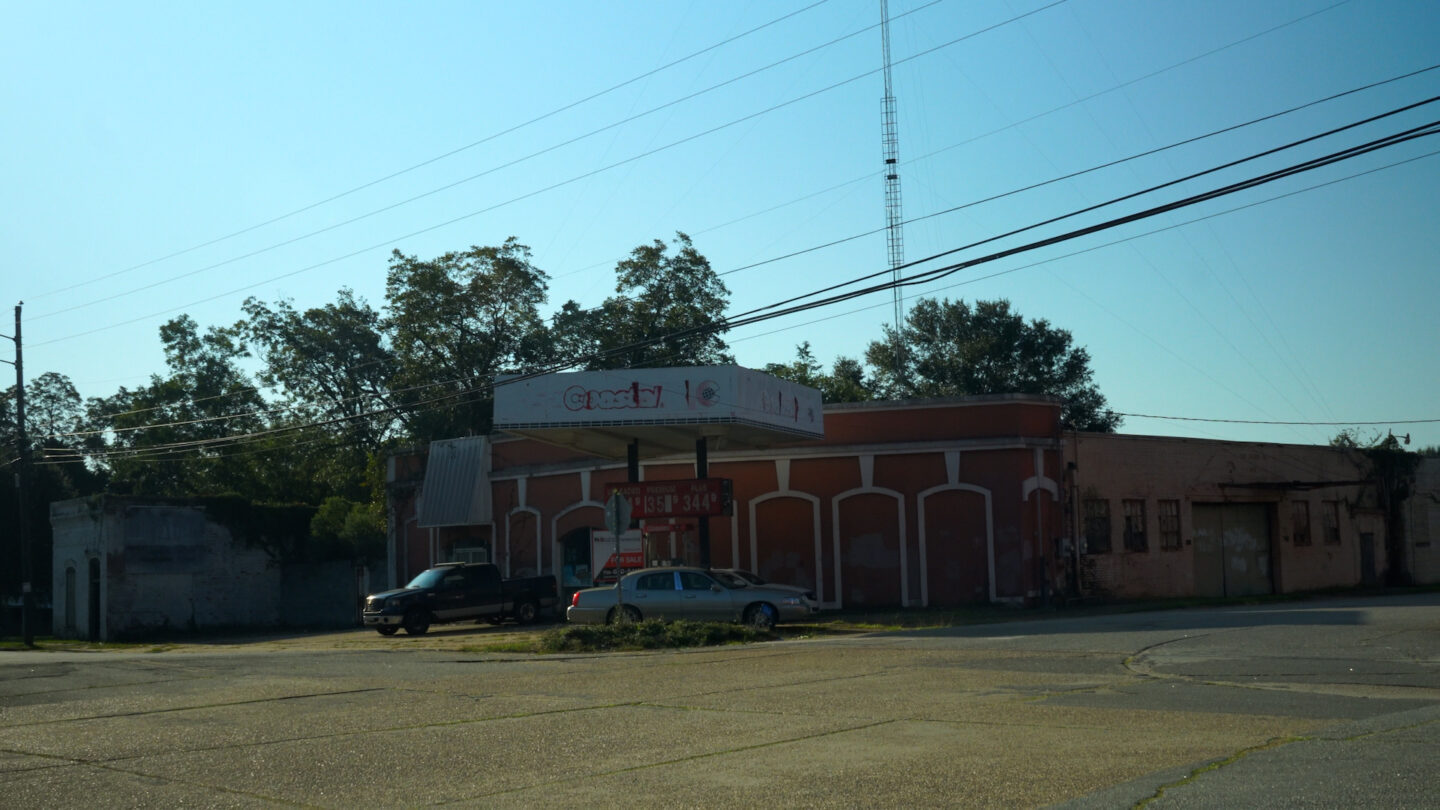 A building and parking lot with power lines overhead in Lumpkin, Georgia.