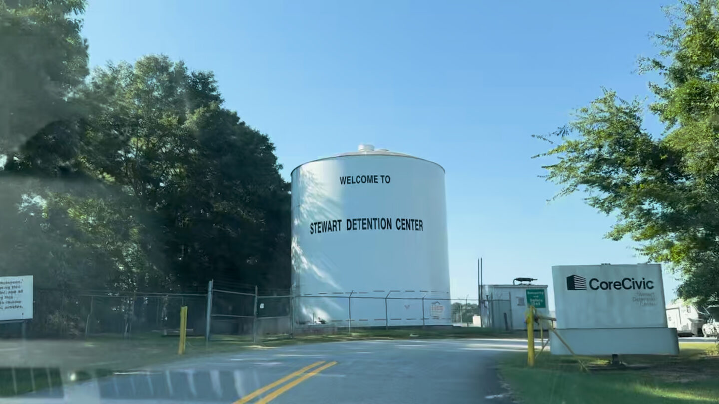 A white cylindrical tank with black lettering stating Stewart Detention Center.