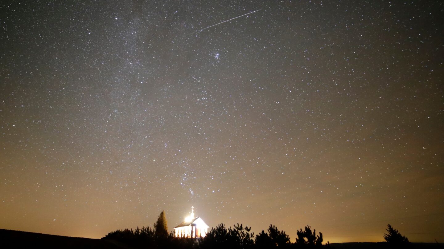 A meteor is seen in the dark sky