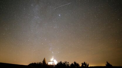 A meteor is seen in the dark sky