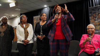 Rev. Dr. Bernice A. King speaks in a room with others.