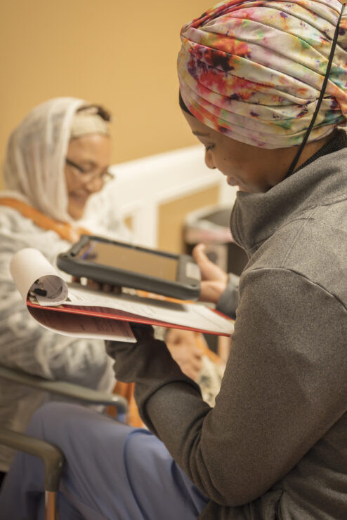 A health care worker helps a patient