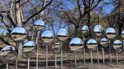 Mirrored installation “Myriad”, reflecting park paths and trees.