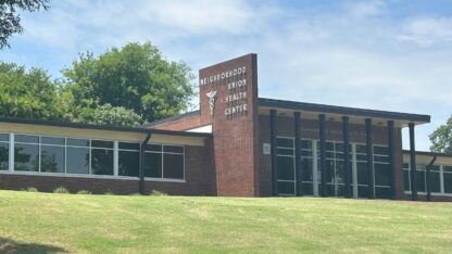 A brick building is shown on a sunny day