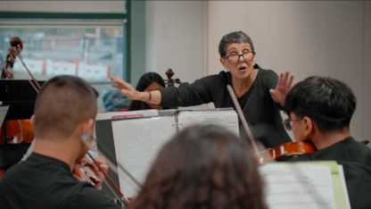 Juana Alzaga conducts students during a rehearsal
