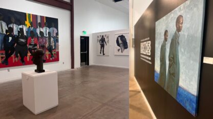 Paintings hang on a gallery wall and a sculpture is seen at ADAMA's “Brother, Brother: The Interior Lives of Black Men” exhibition