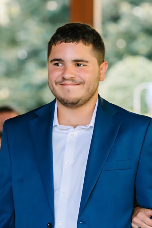 A photo of Aaron Kaminer in a blue jacket.