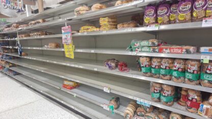 Loaves of bread are shown on mostly empty shelves at a grocery story in Atlanta