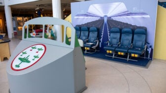 Play pilot seat in front of row of airplane seats