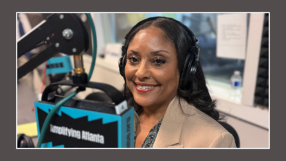 Marci Collier Overstreet sits in the WABE studio in front of a microphone setup
