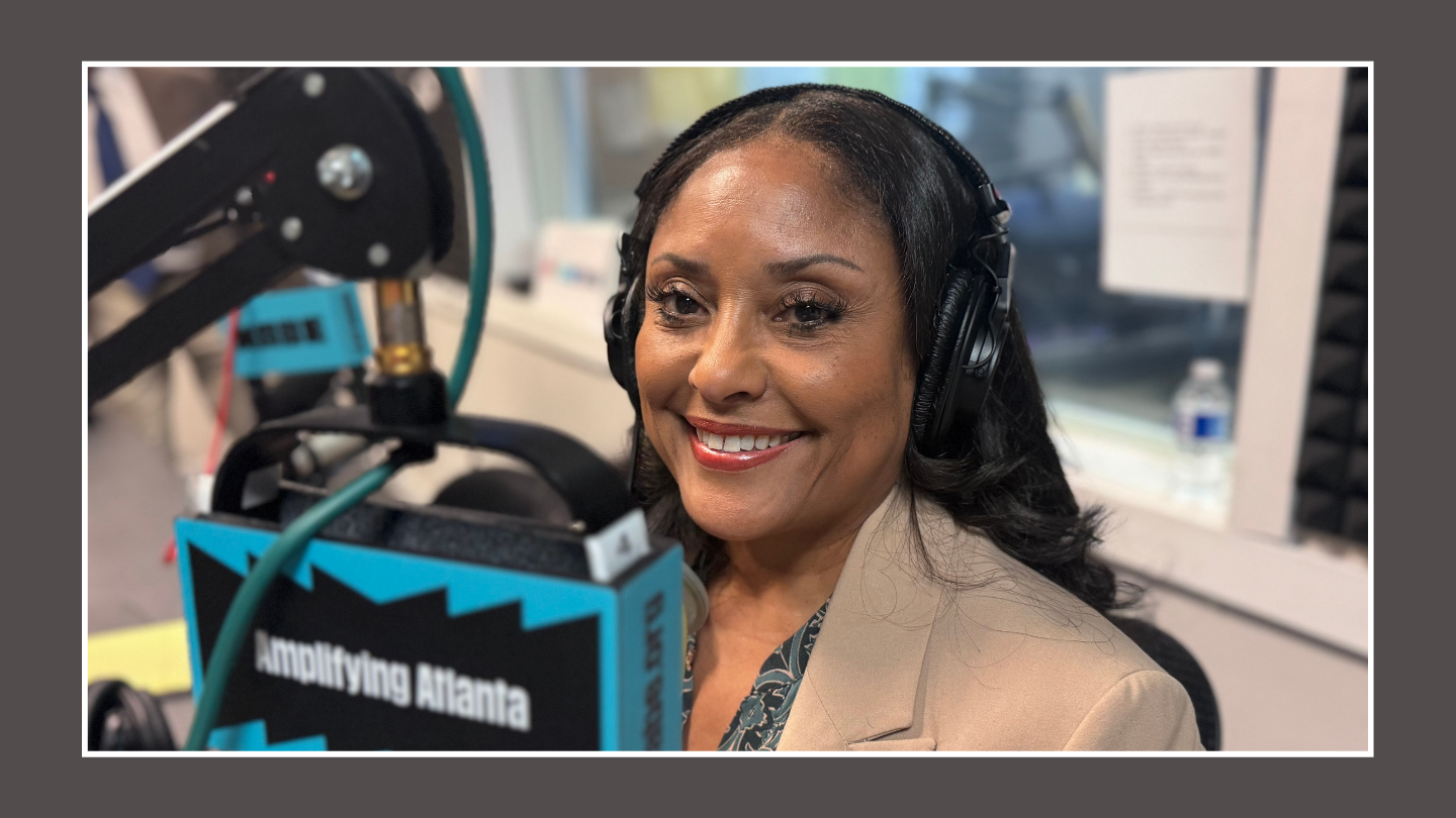 Marci Collier Overstreet sits in the WABE studio in front of a microphone setup