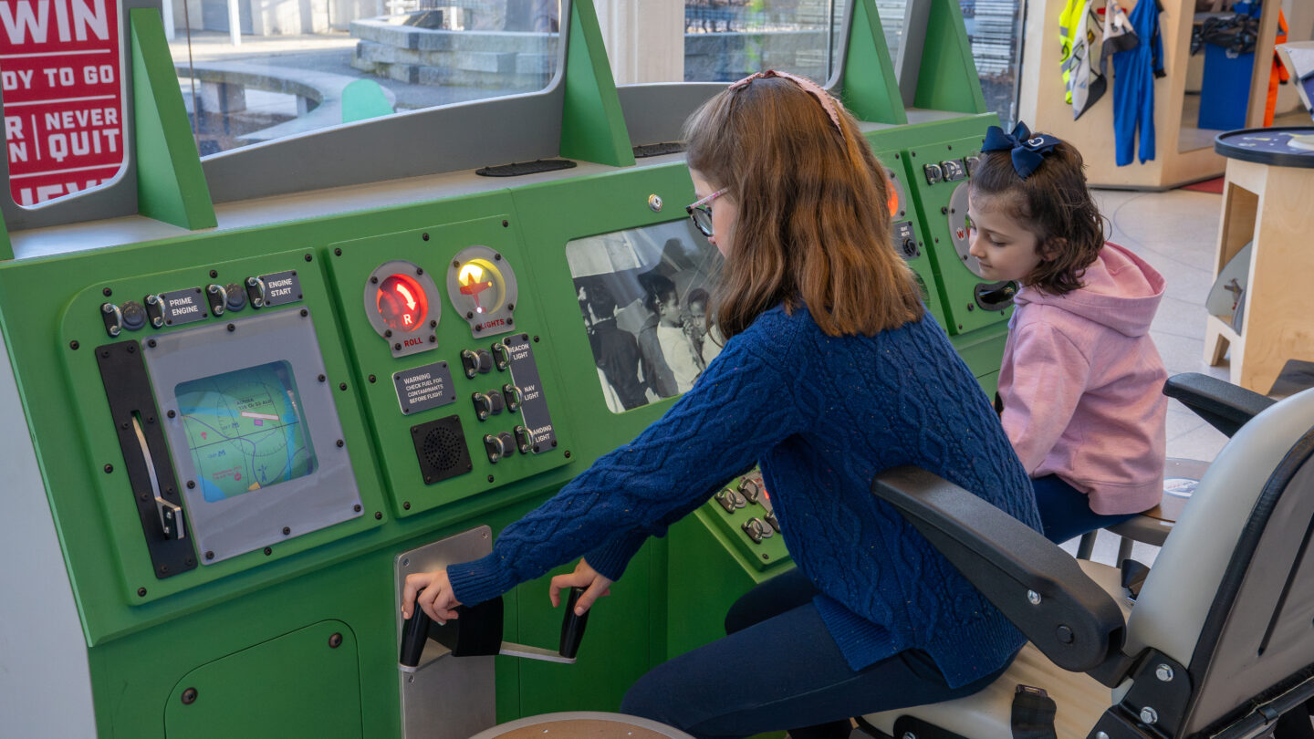 Children using cockpit simulator